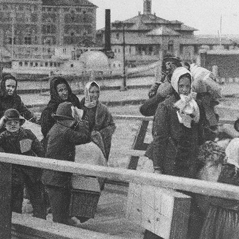 People lining up on Ellis Island in 1902.